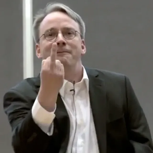 

Person wearing glasses & dress-shirt, smiling with forehead & arm exposed