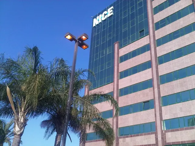 Sky, tower-block & tree lit by "NICE" street