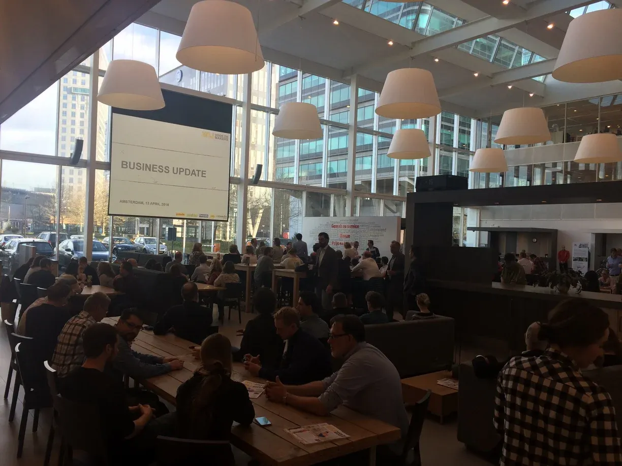 Crowd of suits gathers at event to gain business updates at Amsterdam-